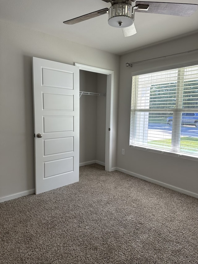 unfurnished bedroom with carpet floors, a closet, and ceiling fan