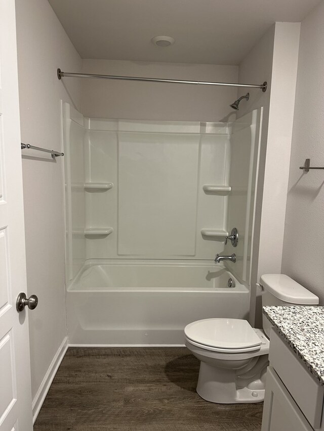 full bathroom with wood-type flooring, toilet, shower / bathing tub combination, and vanity