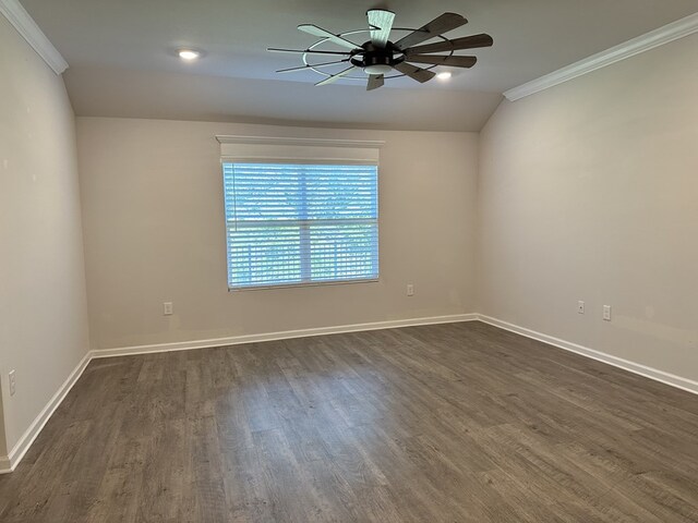 spare room featuring dark wood-type flooring, ceiling fan, lofted ceiling, and crown molding