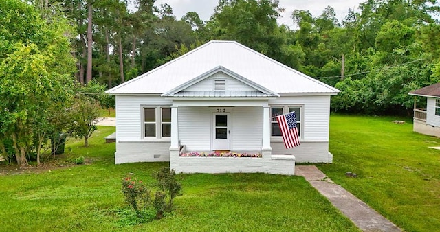 712 Young St, Thomasville, GA 31792 - view of front of home with a front lawn, covered porch, and a metal roof