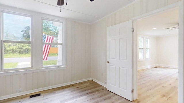 712 Young St, Thomasville, GA 31792 - empty room with ceiling fan, light wood-style floors, healthy amount of natural light, and crown molding