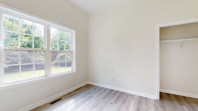 712 Young St, Thomasville, GA 31792 - unfurnished bedroom with multiple windows, light wood finished floors, and a closet