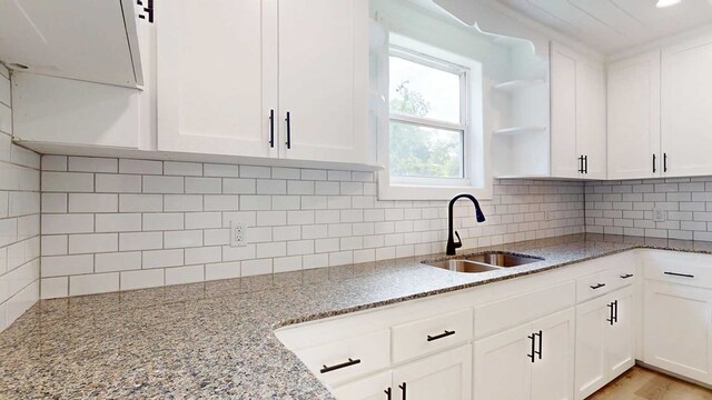 712 Young St, Thomasville, GA 31792 - kitchen with white cabinets and light stone counters