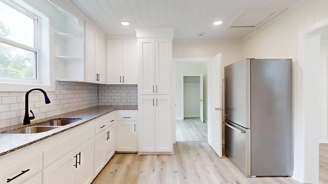 712 Young St, Thomasville, GA 31792 - kitchen featuring freestanding refrigerator, light stone countertops, open shelves, light wood-style flooring, and recessed lighting