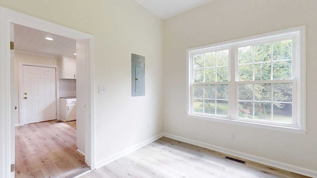 712 Young St, Thomasville, GA 31792 - spare room with electric panel, light wood-style flooring, and recessed lighting