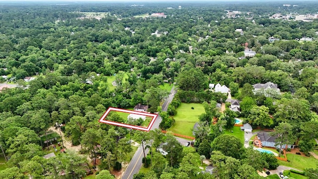 712 Young St, Thomasville, GA 31792 - aerial view of property and surrounding area with property boundaries highlighted and a heavily wooded area