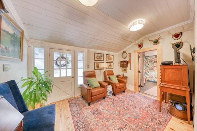 living area featuring light hardwood / wood-style flooring, vaulted ceiling, ornamental molding, and wooden ceiling