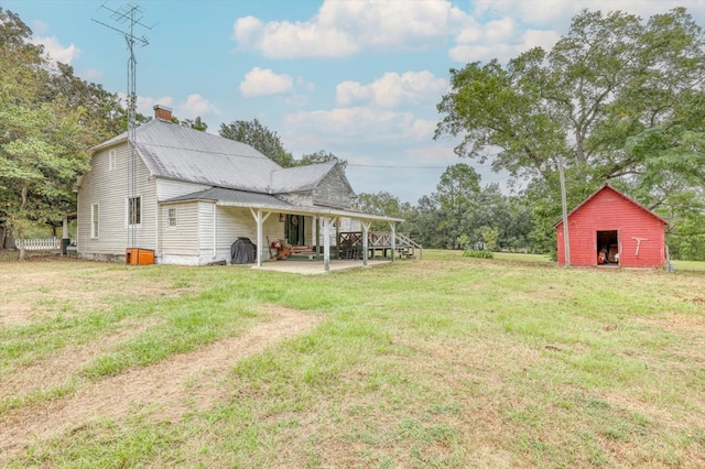 view of yard featuring a storage unit and a patio