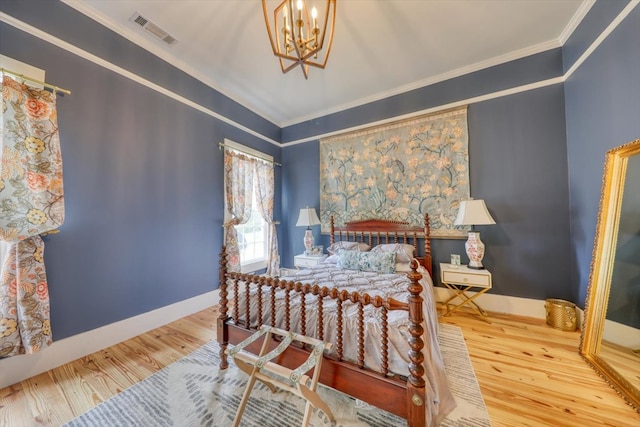 bedroom featuring a notable chandelier, crown molding, and hardwood / wood-style flooring