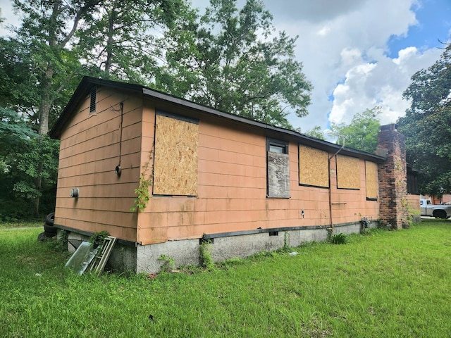 801 Magnolia St, Thomasville, GA 31792 - view of home's exterior with crawl space, a lawn, and a chimney