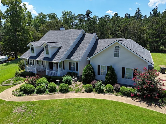 view of front of home with a front yard and covered porch