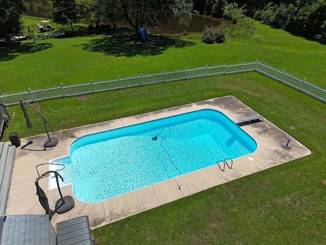 view of pool with a yard