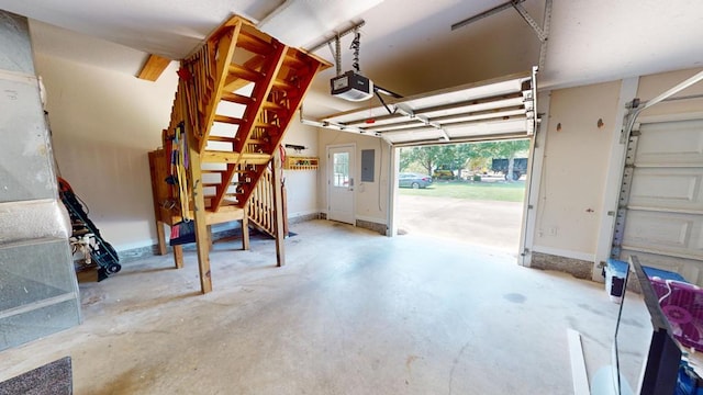 garage with a garage door opener and electric panel