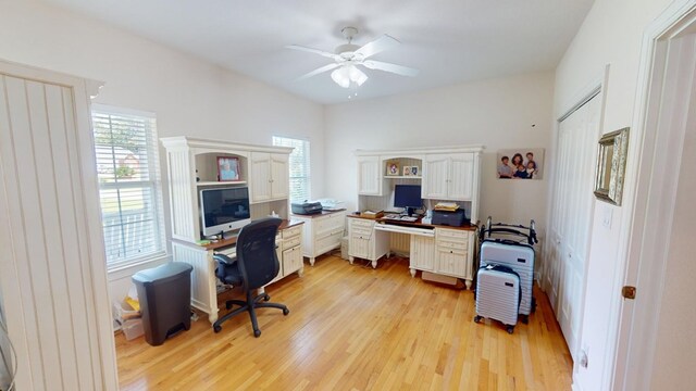 office with light hardwood / wood-style floors and ceiling fan