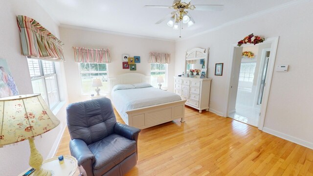 bedroom featuring crown molding, ceiling fan, light hardwood / wood-style floors, and multiple windows