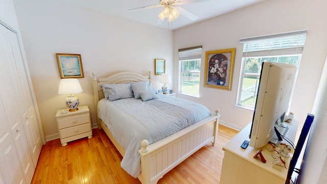 bedroom with ceiling fan and light hardwood / wood-style flooring