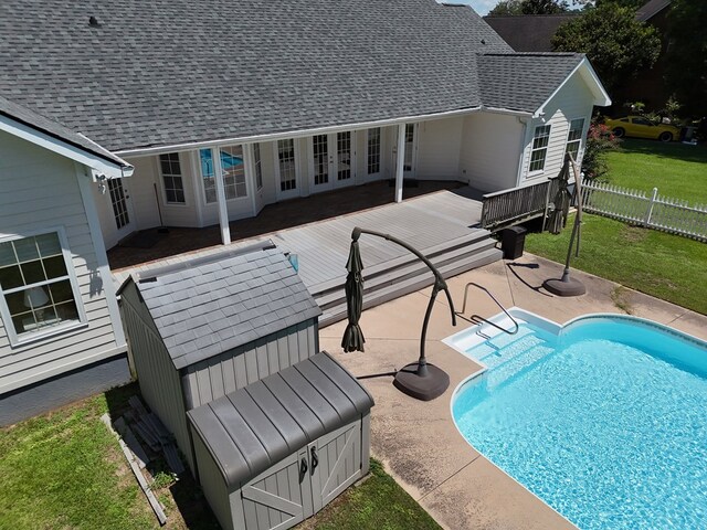 view of swimming pool with a wooden deck and a patio