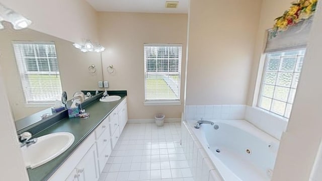 bathroom with a tub to relax in, tile patterned flooring, and vanity