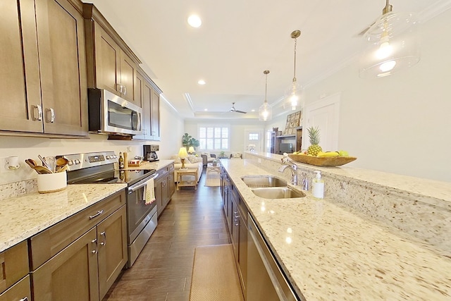 kitchen featuring a sink, ornamental molding, appliances with stainless steel finishes, and recessed lighting