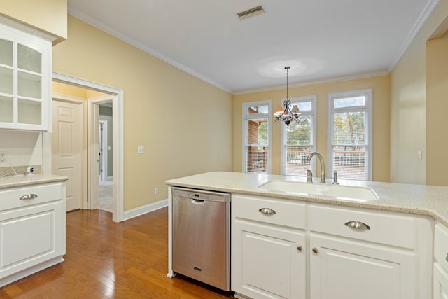 kitchen with sink, ornamental molding, dishwasher, pendant lighting, and white cabinets