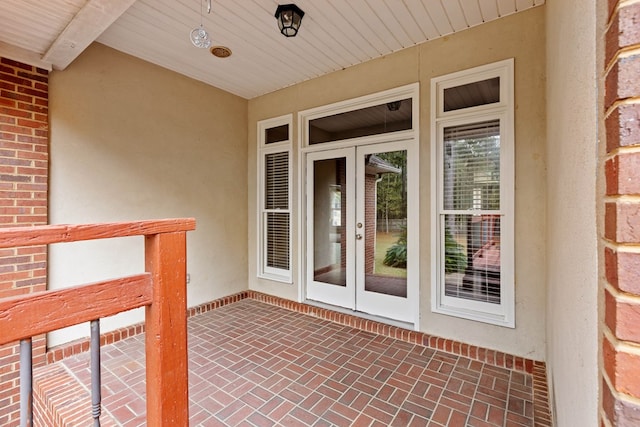 entrance to property featuring french doors and a patio