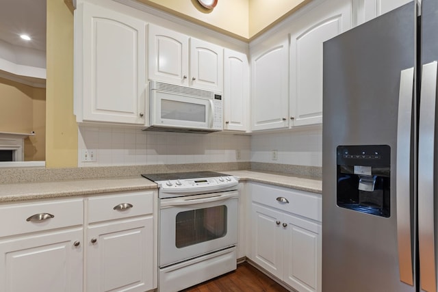 kitchen featuring white cabinetry, dark wood-type flooring, backsplash, and white appliances