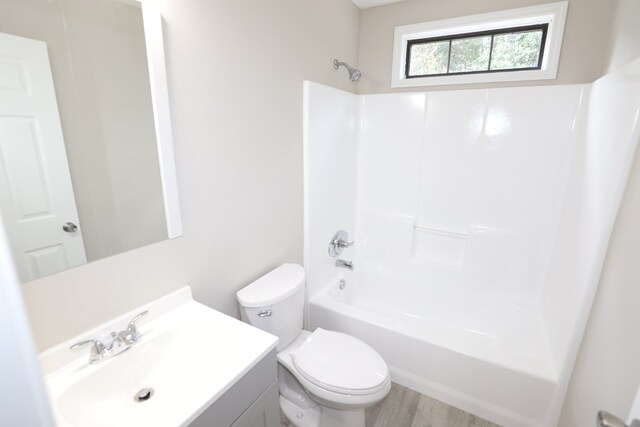 full bathroom featuring vanity, wood-type flooring, tub / shower combination, and toilet