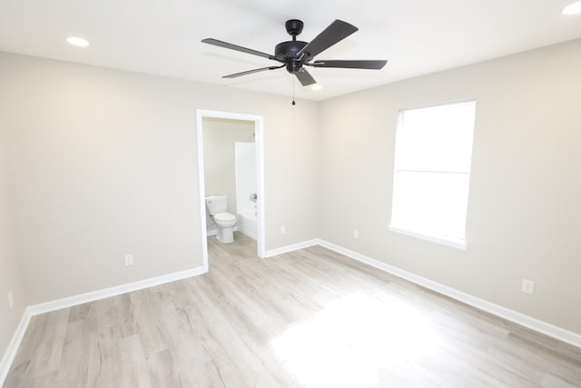 unfurnished bedroom featuring ceiling fan, connected bathroom, and light wood-type flooring