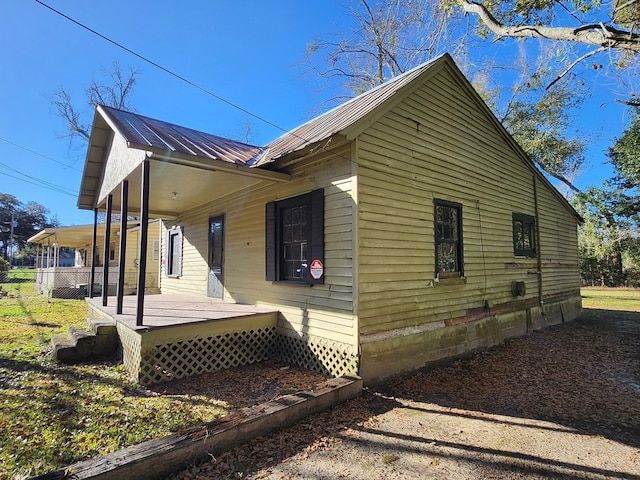 view of side of property featuring metal roof