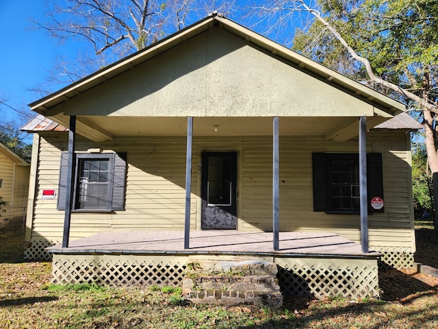 back of house featuring a porch