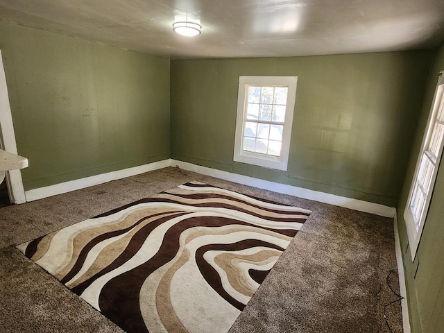 unfurnished bedroom with carpet and baseboards