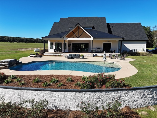 view of swimming pool featuring a patio and a lawn