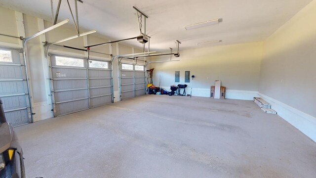 garage featuring a garage door opener and electric panel