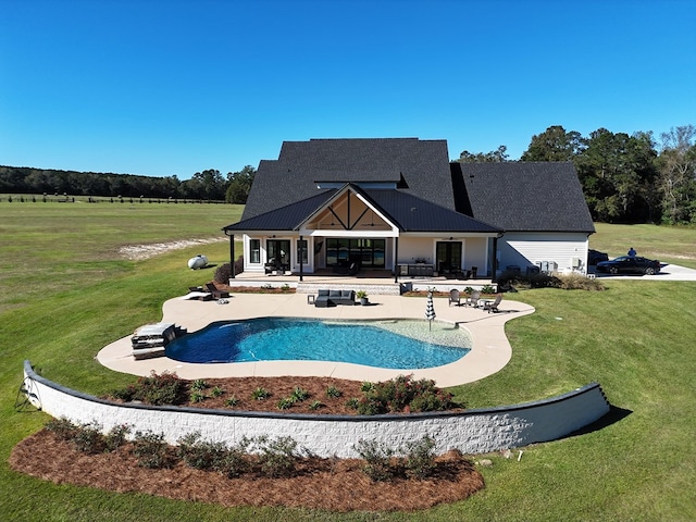 view of swimming pool featuring a patio and a lawn