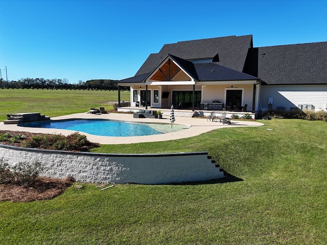 view of swimming pool with a yard and a patio area