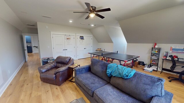 interior space with vaulted ceiling, ceiling fan, and light hardwood / wood-style flooring