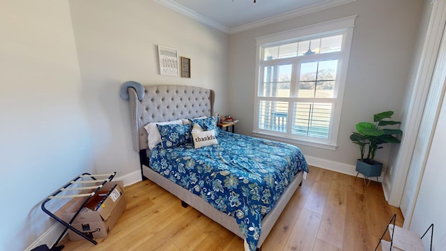 bedroom with crown molding and light wood-type flooring