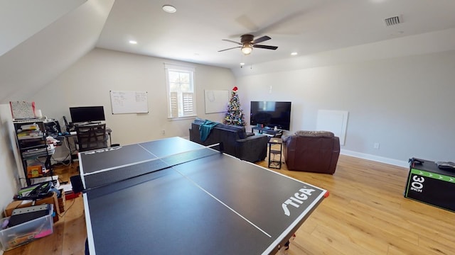 recreation room with lofted ceiling, ceiling fan, and light wood-type flooring