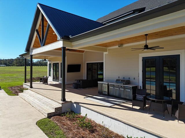 view of patio with exterior kitchen, area for grilling, and ceiling fan