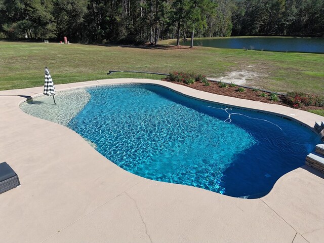 view of pool featuring a yard and a water view