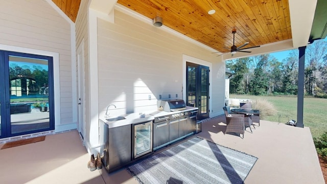 view of patio / terrace featuring area for grilling, wine cooler, and ceiling fan