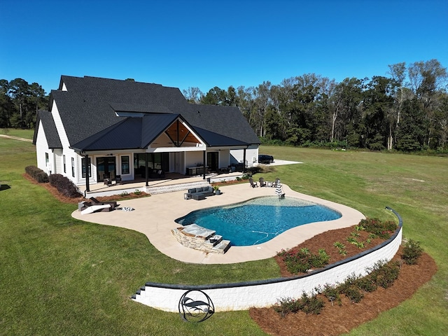 view of pool with a yard and a patio area