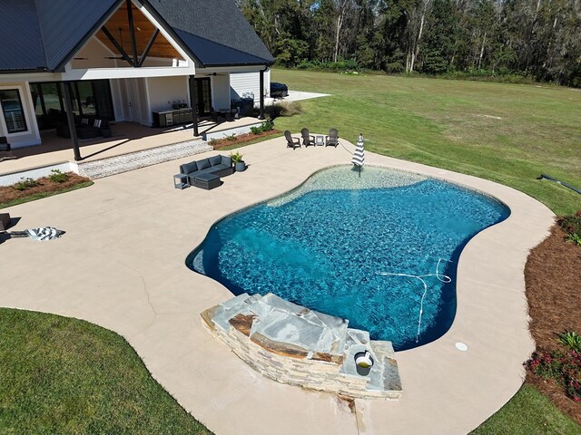 view of swimming pool with a patio and a yard