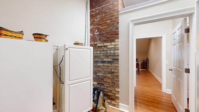 hallway with light wood-style floors and baseboards