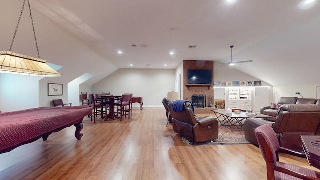 game room featuring lofted ceiling, wood finished floors, a ceiling fan, pool table, and a brick fireplace