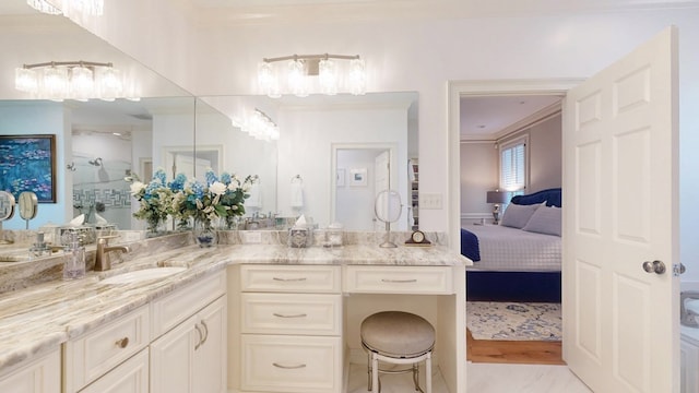 bathroom featuring connected bathroom, vanity, and ornamental molding