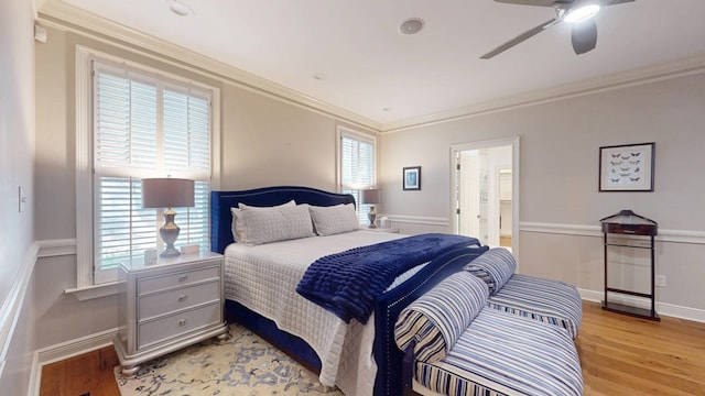 bedroom featuring light wood-type flooring, crown molding, and ceiling fan
