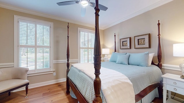 bedroom featuring multiple windows, wood finished floors, ornamental molding, baseboards, and ceiling fan