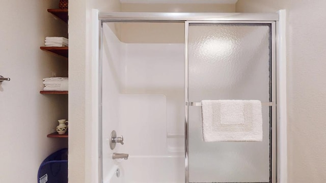 full bathroom with bath / shower combo with glass door