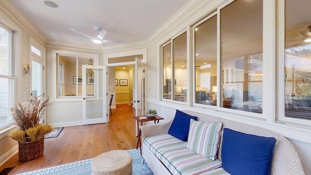 sunroom with hardwood / wood-style floors and crown molding